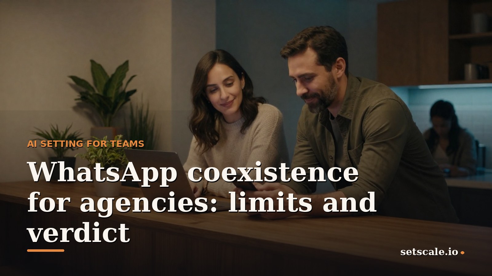 Man around thirty with dark hair and a two day beard, wearing an olive green overshirt, leaning on a tall walnut counter in a warm agency kitchen, holding a smartphone next to an open laptop, soft warm light on his face and a cool blue tone in the background